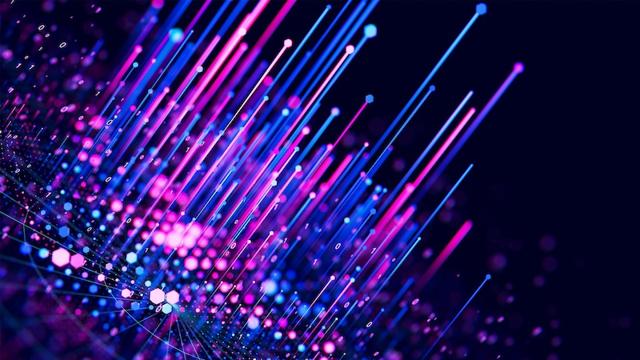 Abstract image of vibrant pink and blue light beams and particles on a dark background, resembling a digital or fiber optic network.